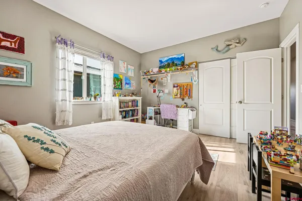 a bedroom with a large bed and a window