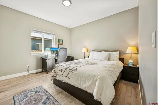 a bedroom with a bed and a view of kitchen