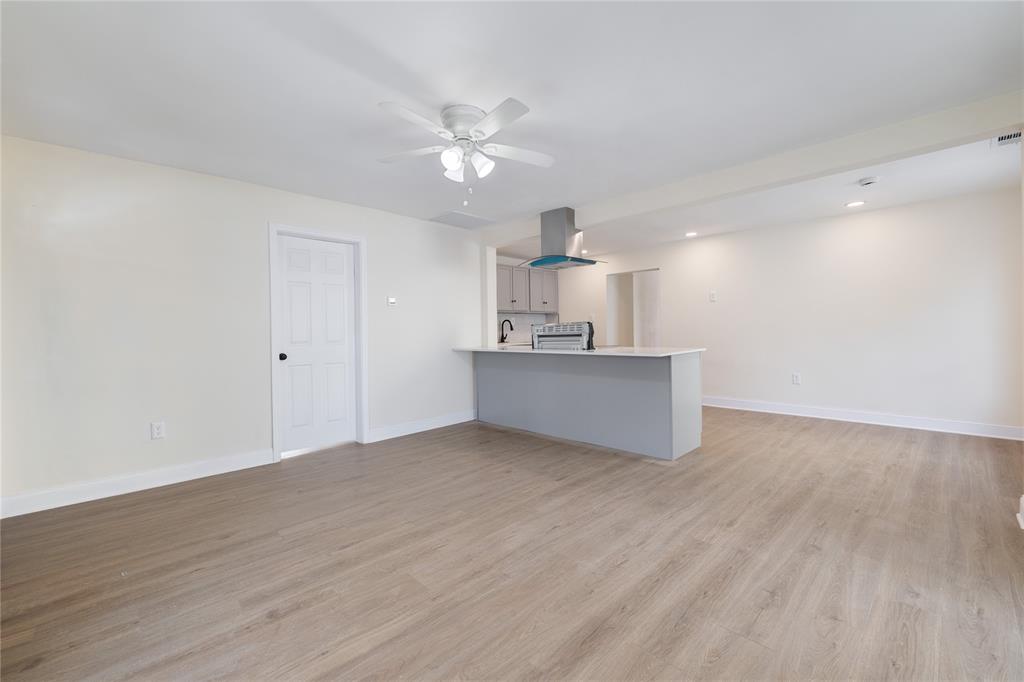 1715 Navaro Street Dallas, TX 75208 - Photo 12 of 33 Unfurnished living room featuring light wood-style floors, recessed lighting, and ceiling fan