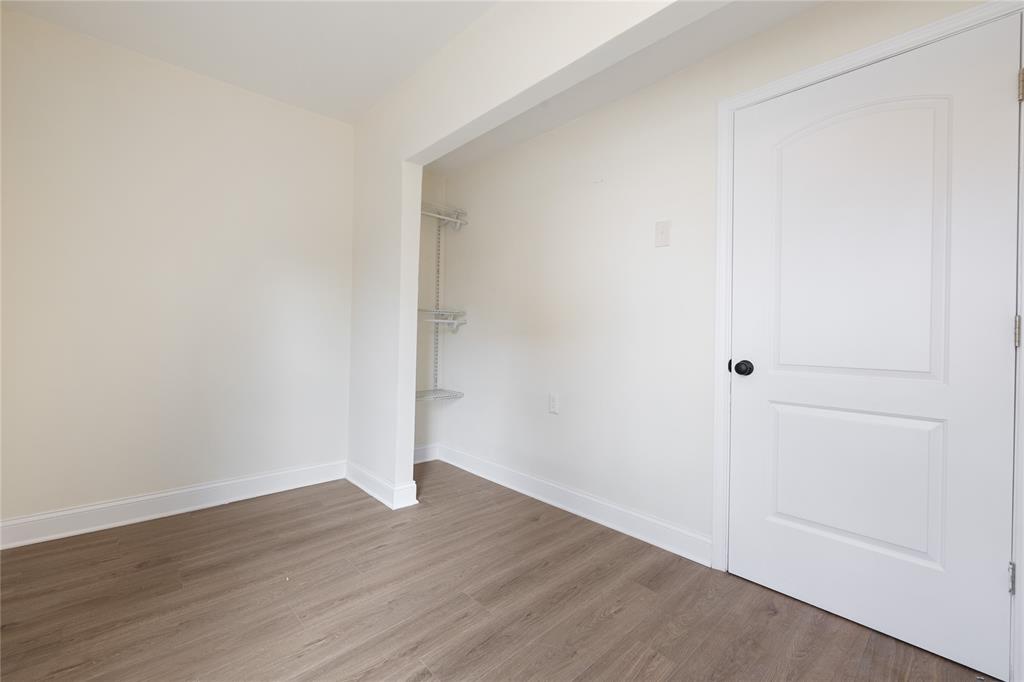 1715 Navaro Street Dallas, TX 75208 - Photo 22 of 33 Unfurnished bedroom featuring wood finished floors and baseboards