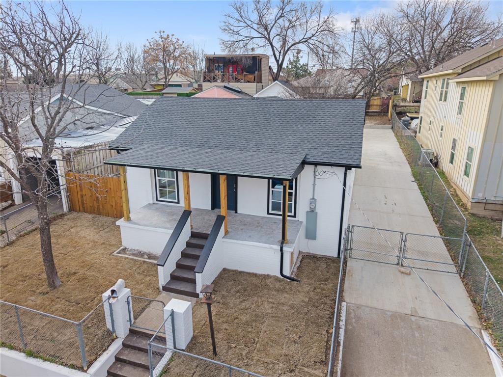 1715 Navaro Street Dallas, TX 75208 - Photo 3 of 33 View of front facade featuring a shingled roof, a fenced front yard, a gate, driveway, and covered porch
