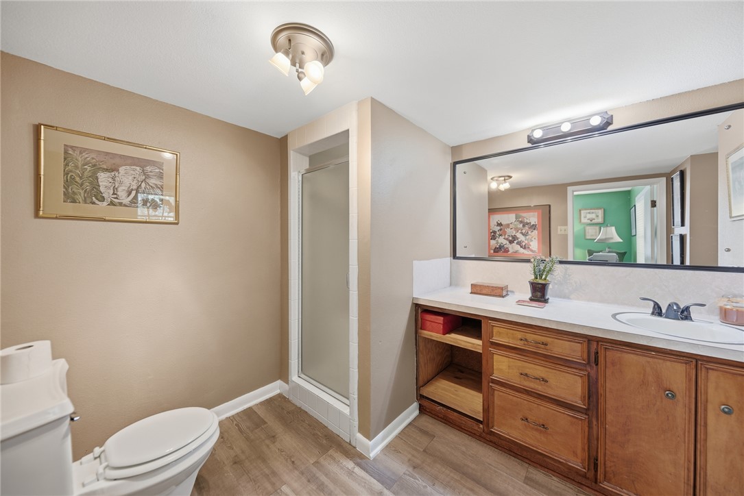 1703 South Day Street Brenham, TX 77833 - Photo 15 of 41 a bathroom with a toilet sink and mirror