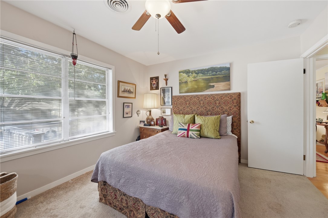 1703 South Day Street Brenham, TX 77833 - Photo 17 of 41 a bedroom with a large bed and a window