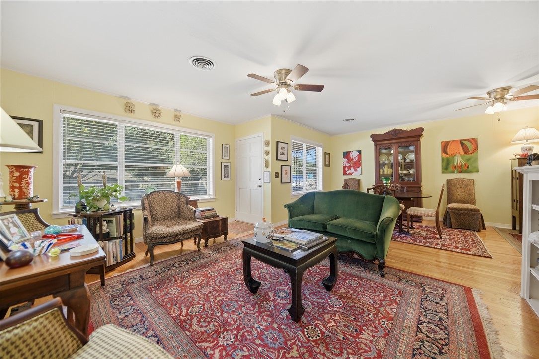 1703 South Day Street Brenham, TX 77833 - Photo 2 of 41 a living room with furniture a rug and a window