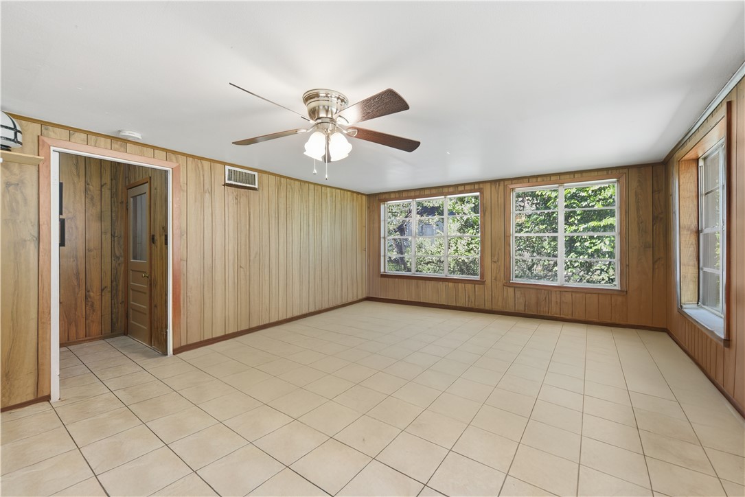 1703 South Day Street Brenham, TX 77833 - Photo 26 of 41 an empty room with windows and fan