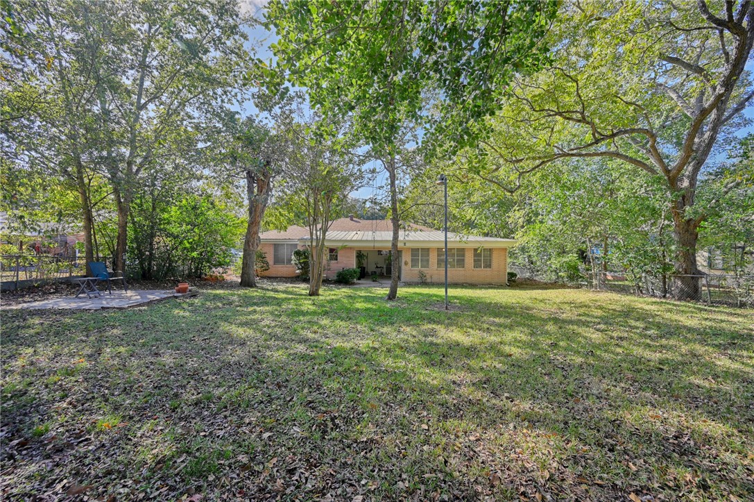 1703 South Day Street Brenham, TX 77833 - Photo 32 of 41 a front view of a house with a garden