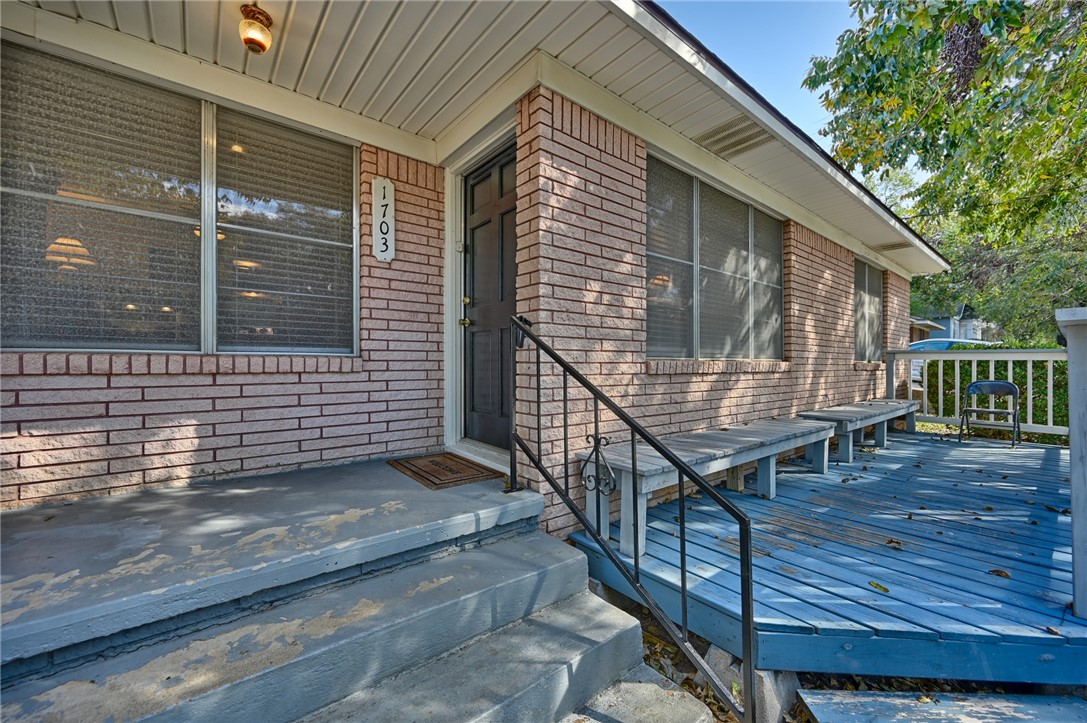 1703 South Day Street Brenham, TX 77833 - Photo 36 of 41 a view of house with wooden deck and a large window