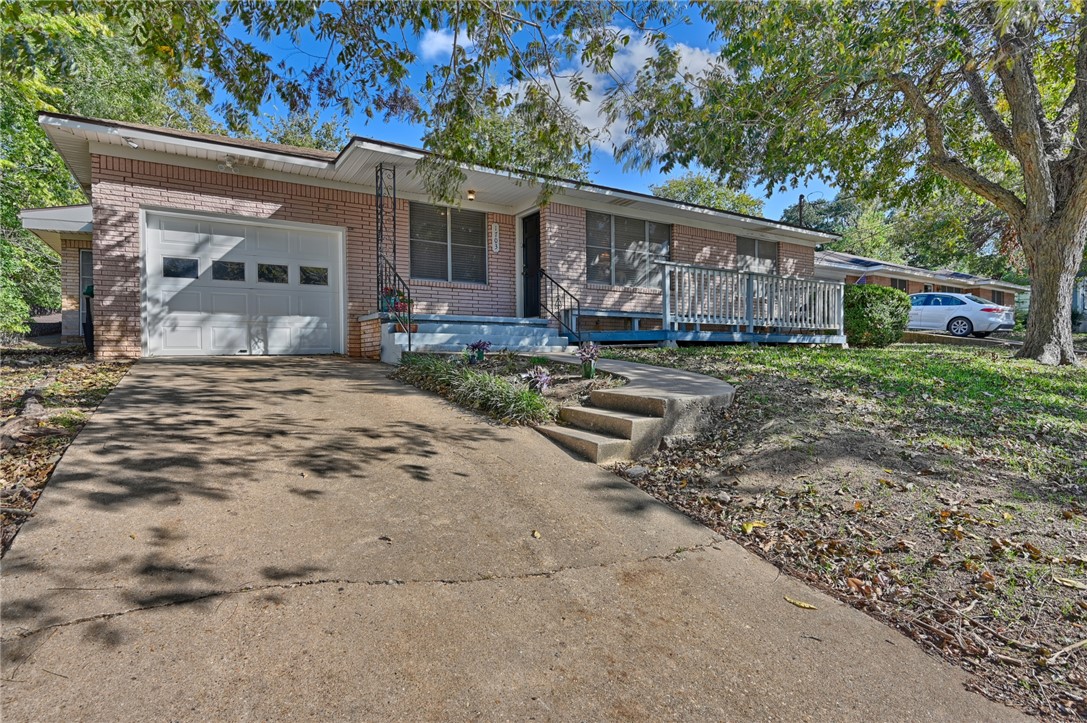 1703 South Day Street Brenham, TX 77833 - Photo 38 of 41 a view of a house with backyard and sitting area
