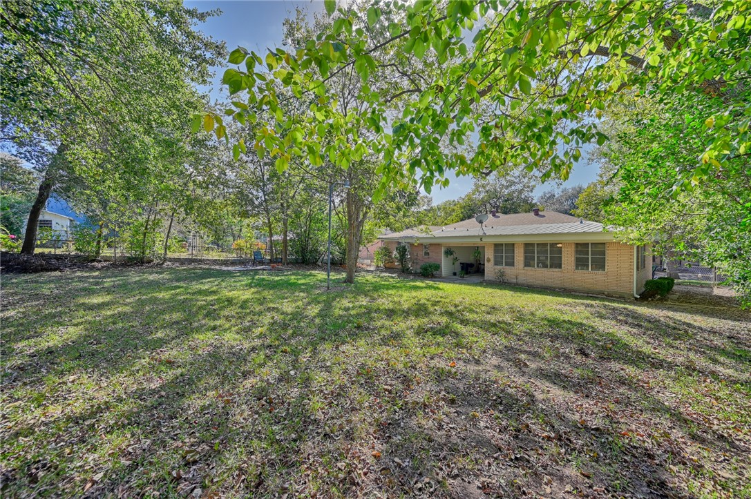 1703 South Day Street Brenham, TX 77833 - Photo 40 of 41 a front view of a house with a garden