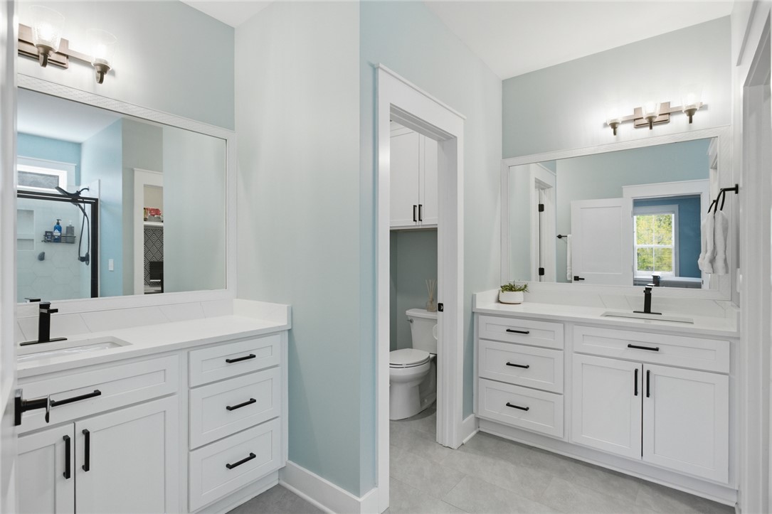 318 Summerall Drive Anderson, SC 29621 - Photo 15 of 41 This spacious bathroom offers dual vanities and modern fixtures, creating a bright and airy feel.