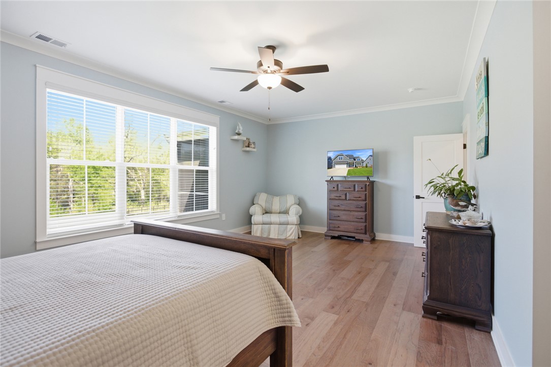 318 Summerall Drive Anderson, SC 29621 - Photo 17 of 41 Bright and airy bedroom with gleaming hardwood floors, ample natural light, and crown molding.