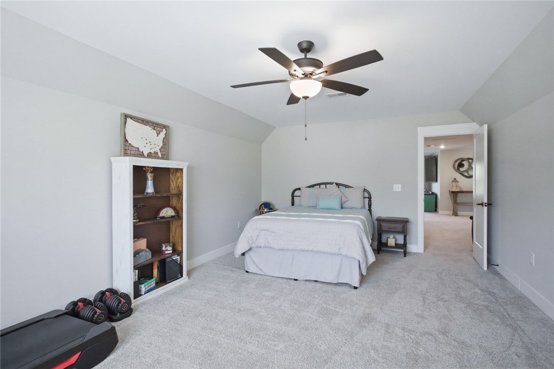 318 Summerall Drive Anderson, SC 29621 - Photo 24 of 41 This spacious bedroom features a ceiling fan, plush carpeting, and an open doorway leading to an adjacent area.