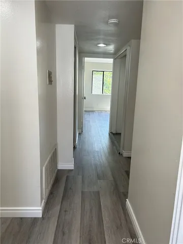 a view of a hallway with wooden floor