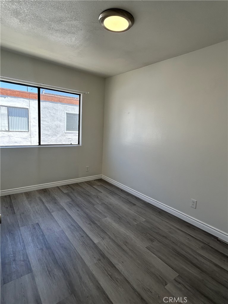 400 South Garfield Avenue, Unit 5 Alhambra, CA 91801 - Photo 12 of 23 an empty room with wooden floor and windows