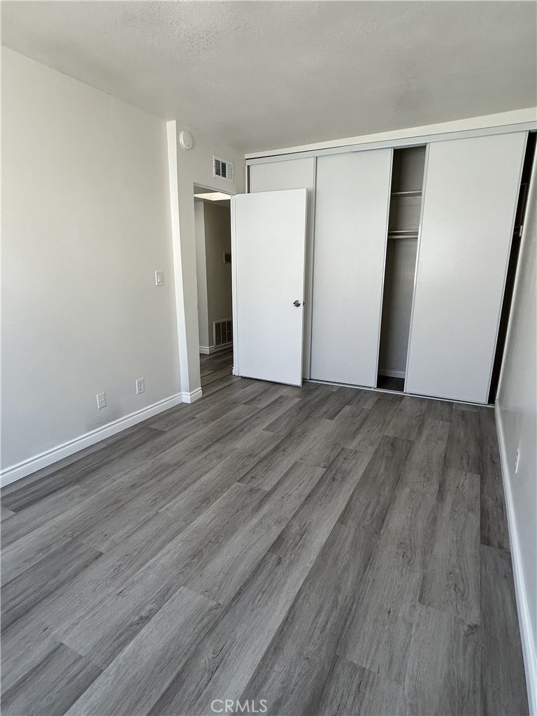 400 South Garfield Avenue, Unit 5 Alhambra, CA 91801 - Photo 15 of 23 an empty room with wooden floor and closet