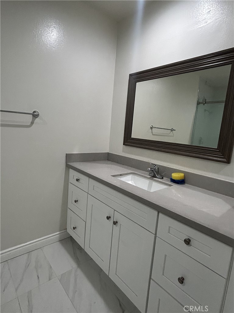 400 South Garfield Avenue, Unit 5 Alhambra, CA 91801 - Photo 16 of 23 a bathroom with a sink and mirror