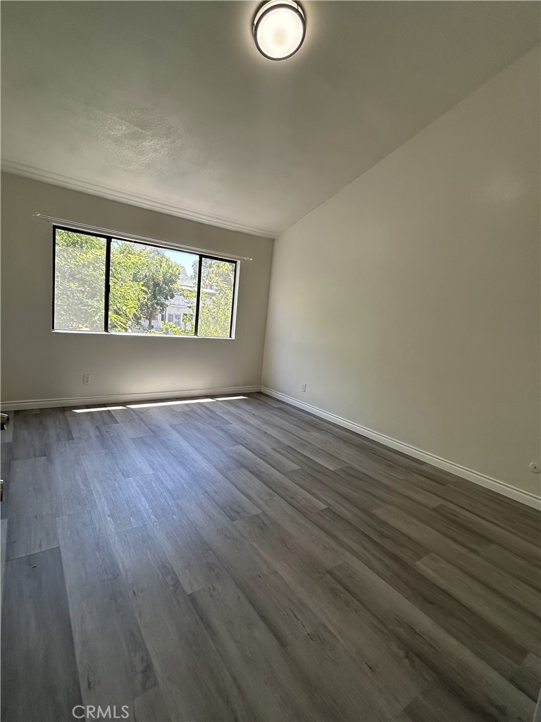 400 South Garfield Avenue, Unit 5 Alhambra, CA 91801 - Photo 18 of 23 an empty room with wooden floor and windows