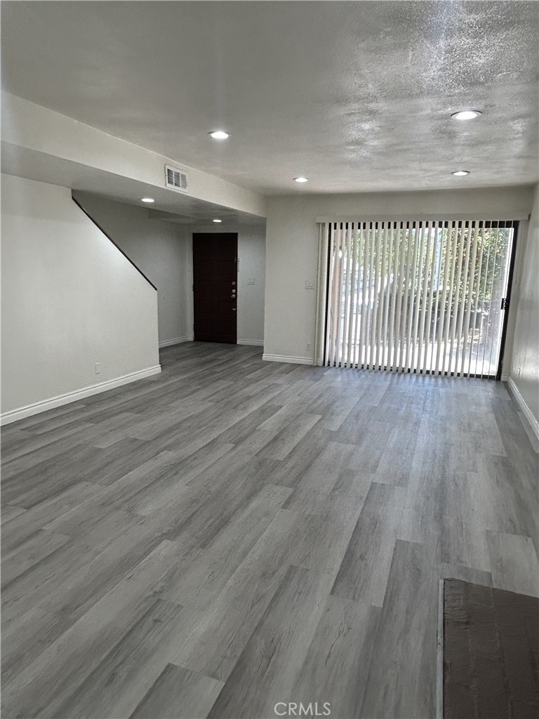 400 South Garfield Avenue, Unit 5 Alhambra, CA 91801 - Photo 4 of 23 an empty room with wooden floor and windows
