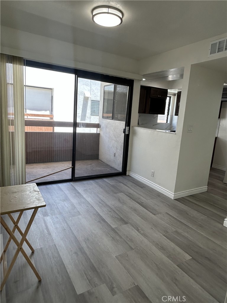 400 South Garfield Avenue, Unit 5 Alhambra, CA 91801 - Photo 5 of 23 a view of a kitchen with furniture and wooden floor
