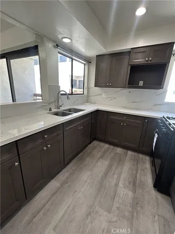 a kitchen with a sink and a stove top oven