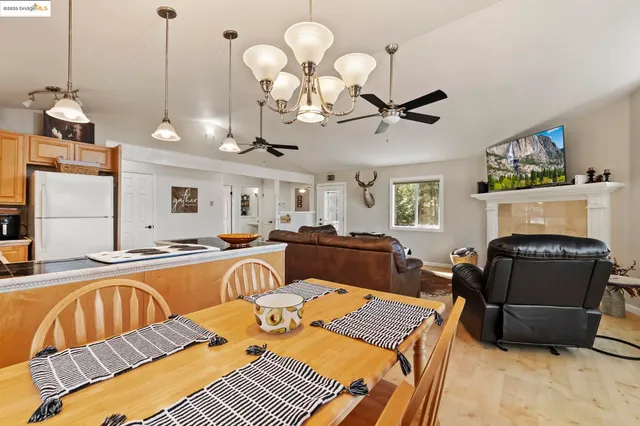 a living room with furniture a fireplace and chandelier
