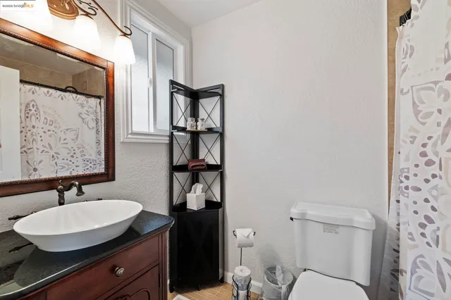 a bathroom with a sink toilet and a mirror