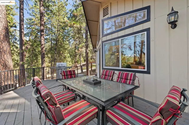 a outdoor living room with furniture and a rug