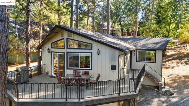 a view of a house with a porch and furniture