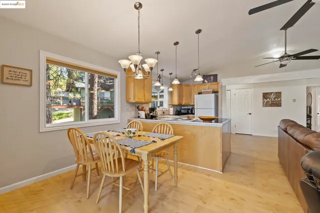 a dining room with furniture a chandelier and window