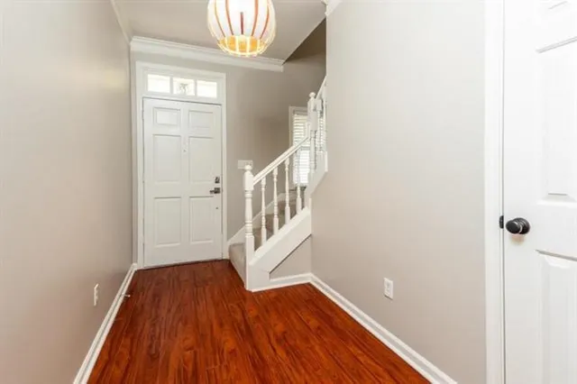 a view of an entryway with wooden floor