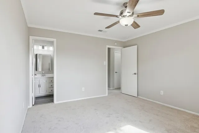 a view of a room with a ceiling fan and a bathroom