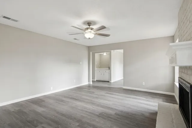 wooden floor in an empty room with a fireplace