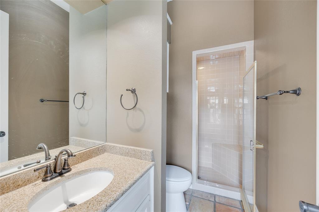 1201 Findlay Drive Arlington, TX 76012 - Photo 11 of 35 a bathroom with a granite countertop sink toilet a mirror and shower