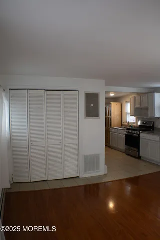 a view of a kitchen with wooden floor and a kitchen