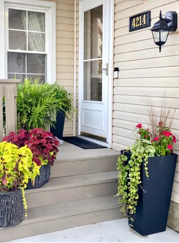 a vase with flowers sitting on a floor