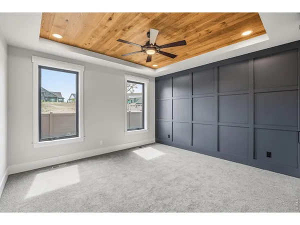 a view of a livingroom with a ceiling fan and window
