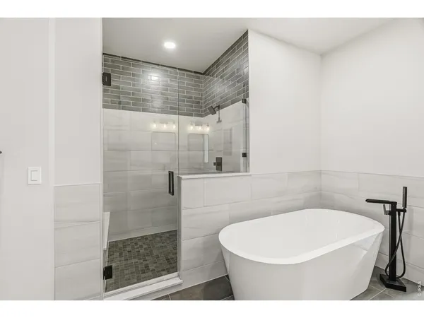 a bathroom with a white bath tub and shower