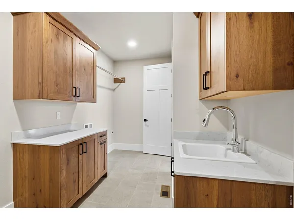 a kitchen with a sink cabinets and wooden floor