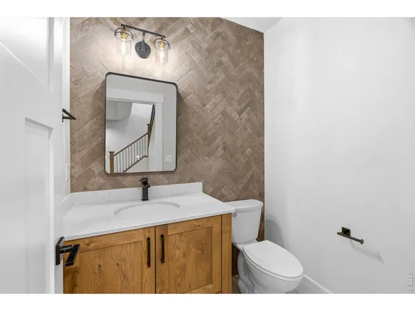 a view of an empty room and a kitchen