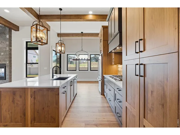 a kitchen with stainless steel appliances granite countertop a stove and a refrigerator