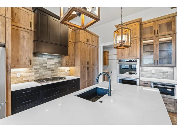a kitchen with stainless steel appliances kitchen island granite countertop a sink and cabinets