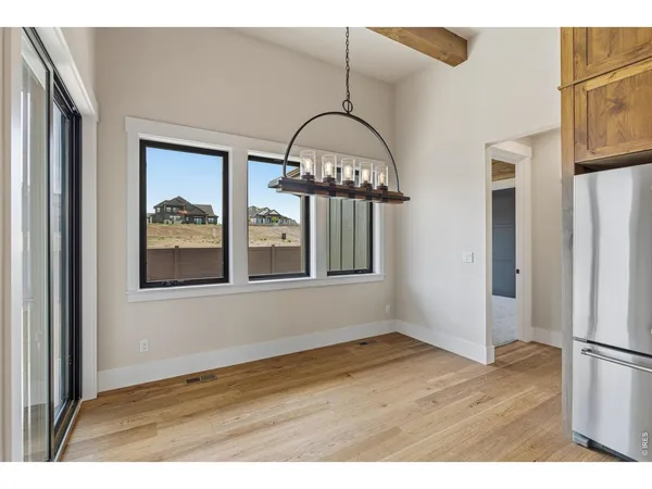 a view of an entryway with wooden floor