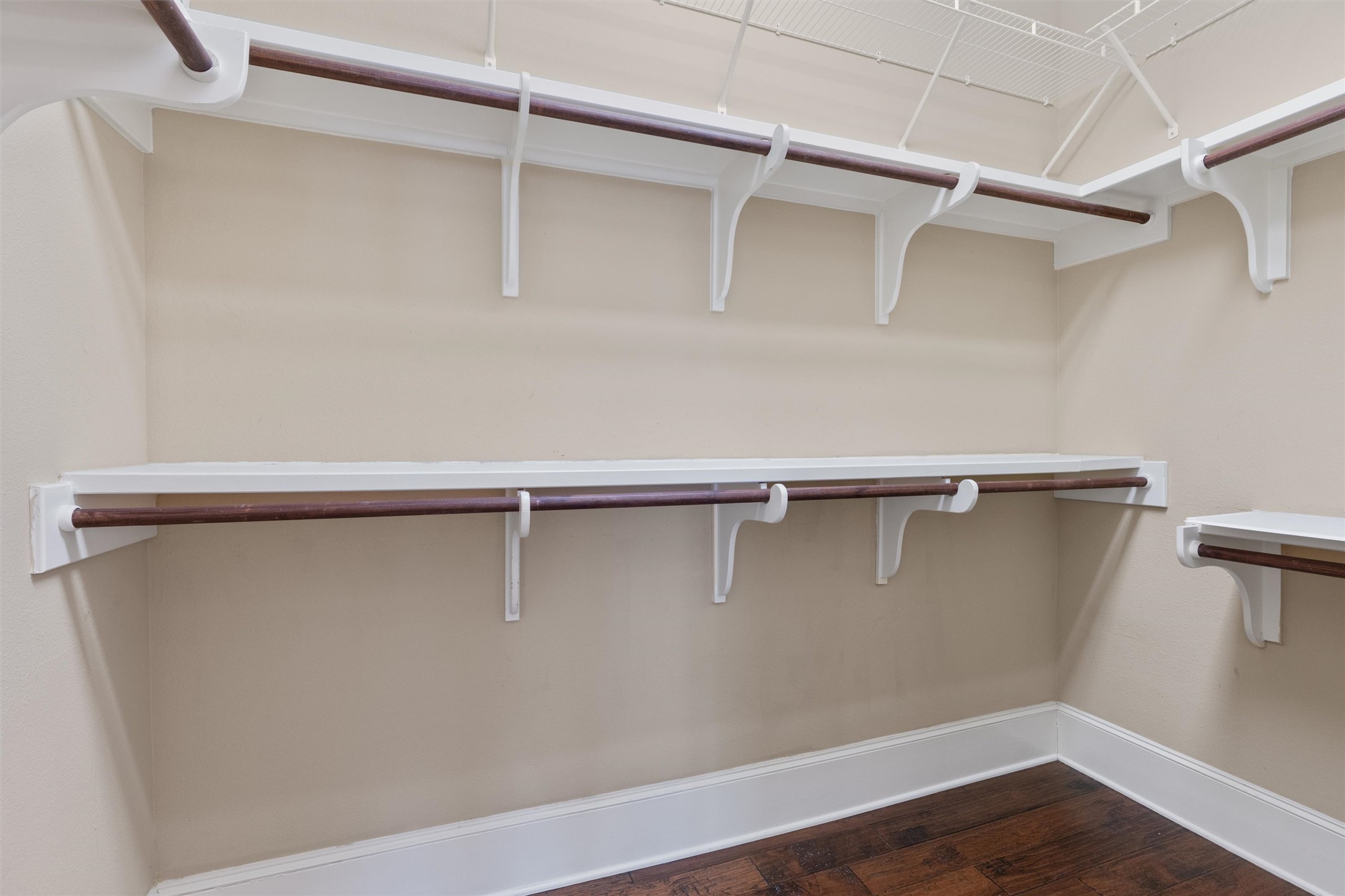 8417 Etienne Cove Austin, TX 78759 - Photo 17 of 35 Functional custom closet system with ample shelving and hanging rods to organize wardrobe essentials.