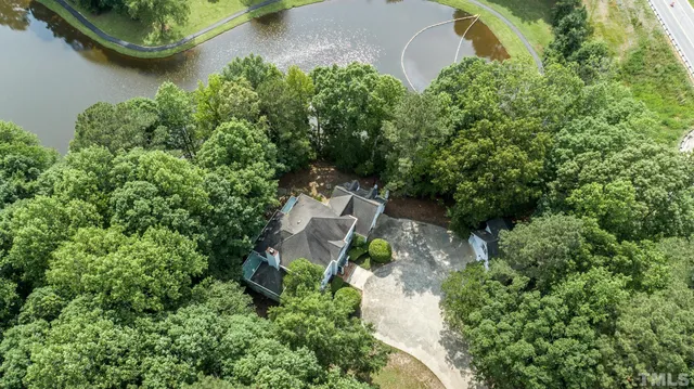 an aerial view of a house with a yard