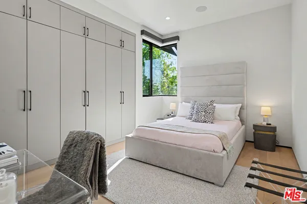 a bedroom with a bed and a chair