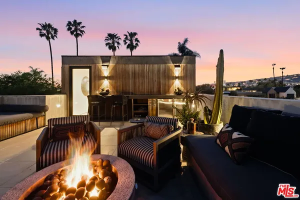 a view of a couches and dinning table in patio