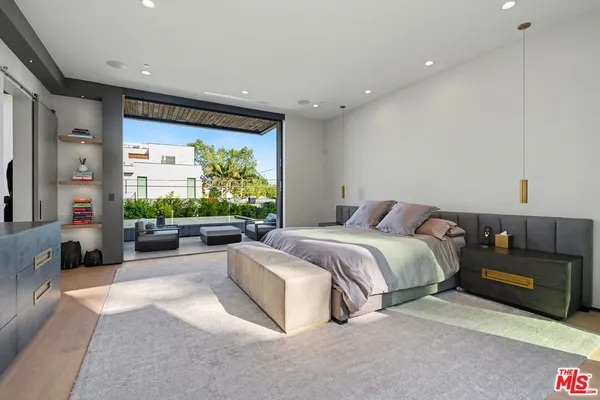 a spacious bedroom with a bed and a couch