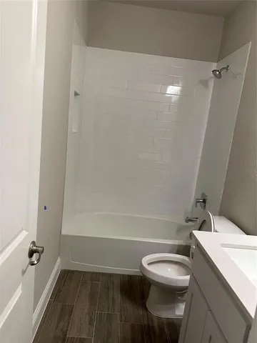a bathroom with a toilet a sink and bathtub
