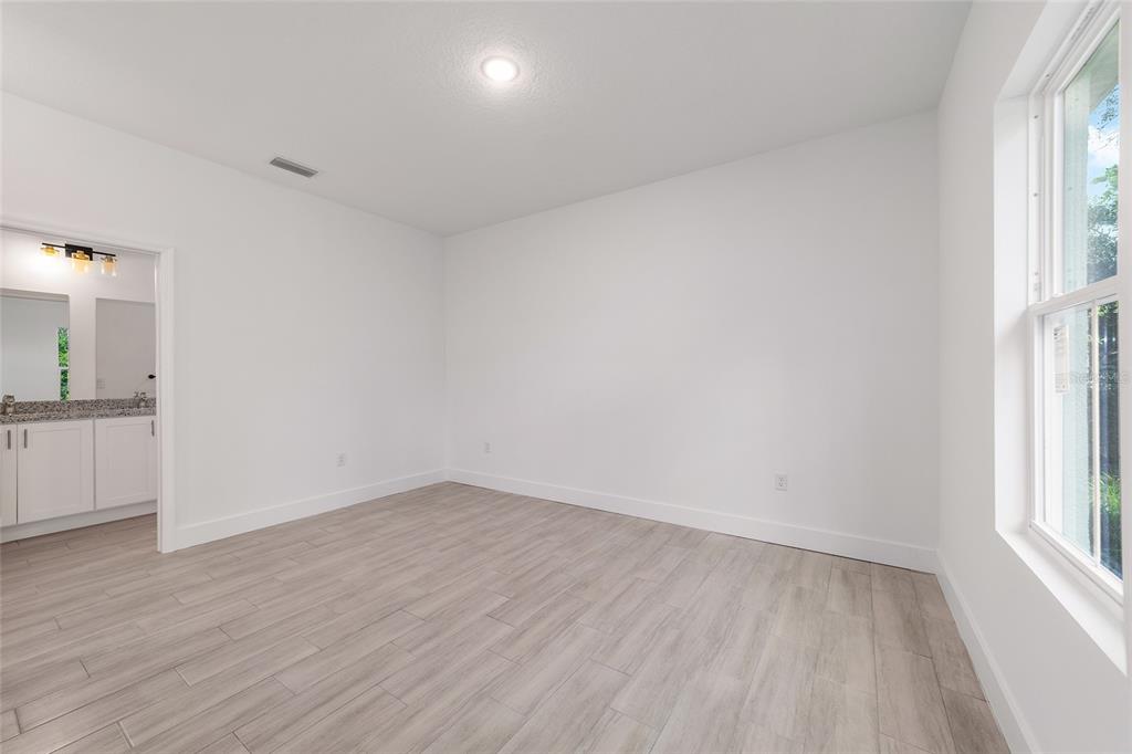 15431 Southwest 41st Street Road Ocala, FL 34481 - Photo 28 of 44 wooden floor in an empty room with a window
