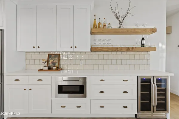 a kitchen with white cabinets and a stove